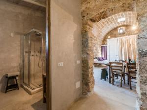 a bathroom with a shower and a dining room at Masseria De Li Travaj - Rive del Salento in Patù +39 photos