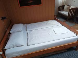 a bed in a room with two white pillows at BpR P3 Lodge Apartment with A/C in Budapest