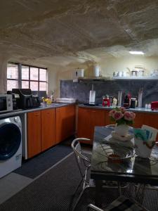a kitchen with a table with a vase of flowers on it at BpR P3 Lodge Apartment with A/C in Budapest