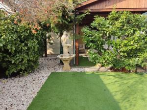 a garden with a fountain and a green lawn at BpR P3 Lodge Apartment with A/C in Budapest