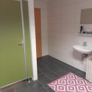 a bathroom with a sink and a toilet and a door at Camping Dorfer in Spielberg