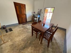 a dining room with a wooden table and chairs at Baboo Studio in Chiang Dao
