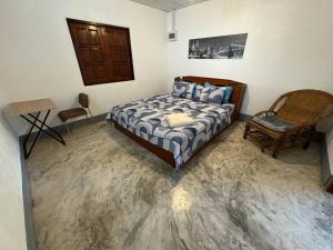 a bedroom with a bed and a chair at Baboo Studio in Chiang Dao