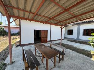 a patio with a wooden table and a bench at Baboo Studio in Chiang Dao +1 photo