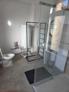 a bathroom with a toilet and a glass shower at Les Nids in Dieppe