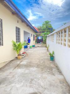 an empty courtyard of a school with a man standing in the background at The Nest Haven Hostel in Dar es Salaam