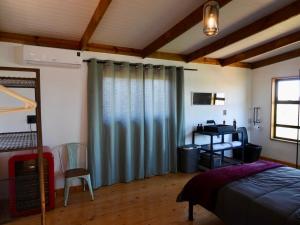 a bedroom with a bed and a desk at Black Sunbird Retreat in Heidelberg