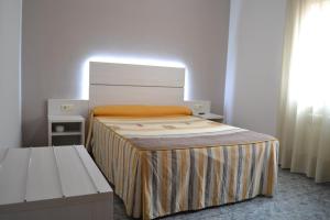Postel nebo postele na pokoji v ubytování Hostal Restaurante El Castillo