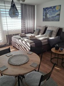 a living room with a couch and a table at Sternenacht in Sankt Englmar +29 photos