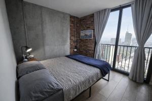 a bedroom with a bed and a large window at BarrioW Apartment 1 Room, parking, pool and view in Monterrey
