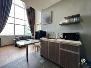 a kitchen and living room with a couch and a table at Metra Square Ayer Keroh MITC in Ayer Keroh +92 photos