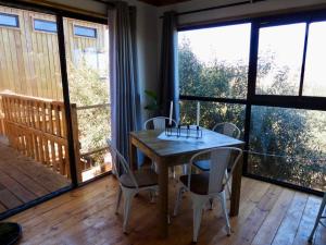 a dining room with a wooden table and chairs at Black Sunbird Retreat in Heidelberg