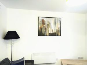a living room with a painting on the wall at Sigma Executive Apartment 5 in South Shields +1 photo