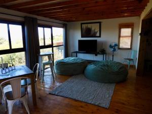 a living room with two bean bag chairs and a table at Black Sunbird Retreat in Heidelberg