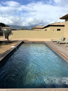 a swimming pool in a yard with a chair at Villas Vangarone in Lecci