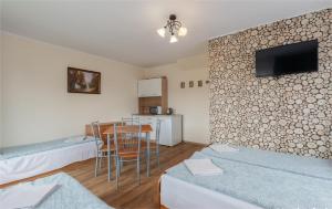 a living room with a kitchen and a dining room at Noclegi Michaś in Krasnobród