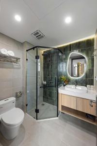a bathroom with a shower and a toilet and a sink at 3A Hometel Hanoi in Hanoi +82 photos