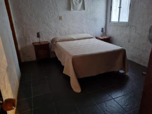 a bedroom with a bed and two night stands at Los Nietos in La Paloma