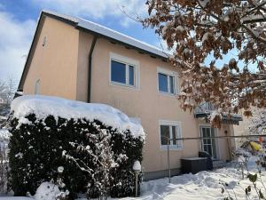 a house with snow on the front of it at Ferienwohnung Bärbel in Freyung +19 photos
