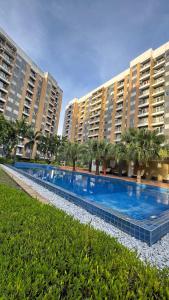 a large swimming pool in front of two large buildings at Mon Amour Haven - 1BR Taytay Rizal in Taytay