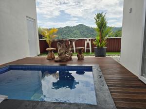 a patio with a table and a swimming pool at Probosiwi Resort Syariah in Talunombo