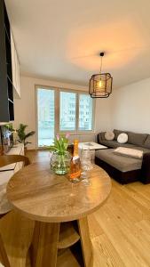a living room with a table with a bottle on it at Prosperity Apartment s parkovaním in Žilina
