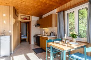 a kitchen with a table and chairs in a room at Casa Sybille, beautiful lake view in Minusio +26 photos