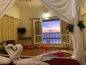 a bedroom with a view of the ocean from a bed at Sealine Beach Resorts in Cherai Beach