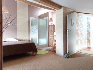 a bedroom with a bed and a glass door at Le Clos de Saint Amour in Montauban +14 photos