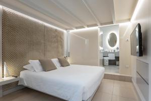 a bedroom with a white bed and a television at Gonfalone 6 in Rome