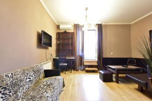 a living room with a leopard print couch and a table at Tbilisi Art Apartment in Tbilisi City
