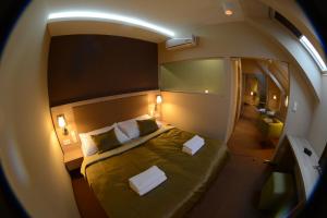 a small room with a bed and a bathroom at Hotel Stardust in Nové Zámky +43 photos
