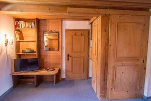 Camera con porta e scrivania con televisore di Pension Landhaus Gasteiger a Kitzbühel
