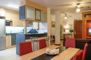 a kitchen and living room with a table and chairs at APARTAMETO BAZTANGOA I Centro Elizondo in Elizondo