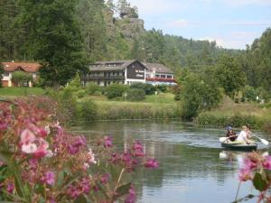 two people are in a boat on a river at Café-Pension Krems in Waischenfeld