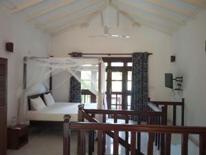 a bedroom with a bed in a room with a window at Hill View Resort in Nakandalagoda