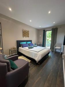 a bedroom with a large bed and a couch at Mas Tareau Chambres d Hotes in Beaucaire