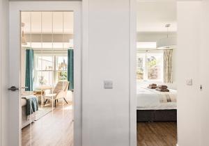 a bedroom with a bed and a table with a chair at Lochburn Cottage in Elie