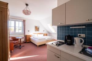 a kitchen with a bedroom and a bed in a room at Gutshaus Barkow in Barkhagen