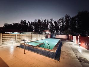 a swimming pool in the middle of a backyard at Starfalls Eco Beach Resort in Irumeni
