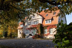 a large house with an orange roof at Gutshaus Barkow in Barkhagen
