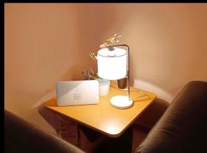 a table with a lamp and a laptop on it at Kinderparadies Norddeich in Norddeich