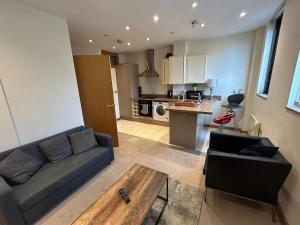 a living room with a couch and a table at Sunderland City Cozy Flat in Sunderland