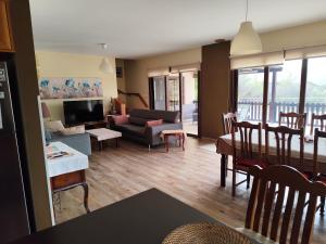 a living room with a couch and a table at Roses Villa in Trimiklini
