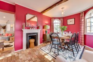 a dining room with red walls and a table and chairs at 2 Bed in Tunstall oc-ivylod in Rendlesham