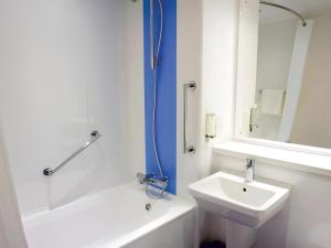 a white bathroom with a sink and a shower at Travelodge Middlesbrough in Middlesbrough