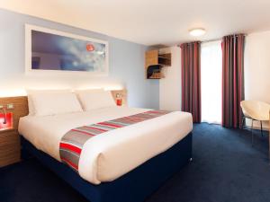 a bedroom with a large bed in a hotel room at Travelodge Middlesbrough in Middlesbrough