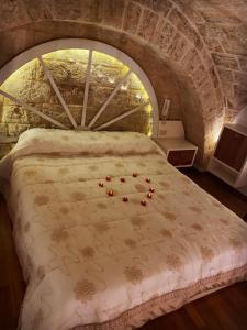 a bedroom with a large bed with a stone wall at San Domenico Suite in Martano