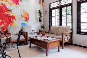 a living room with chairs and a coffee table at RedDoorz @ Soekarno Hatta 2 in Malang
