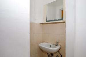a bathroom with a sink and a mirror at RedDoorz @ Soekarno Hatta 2 in Malang +51 photos